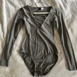 Gray bodysuit plunging next cross cross detail